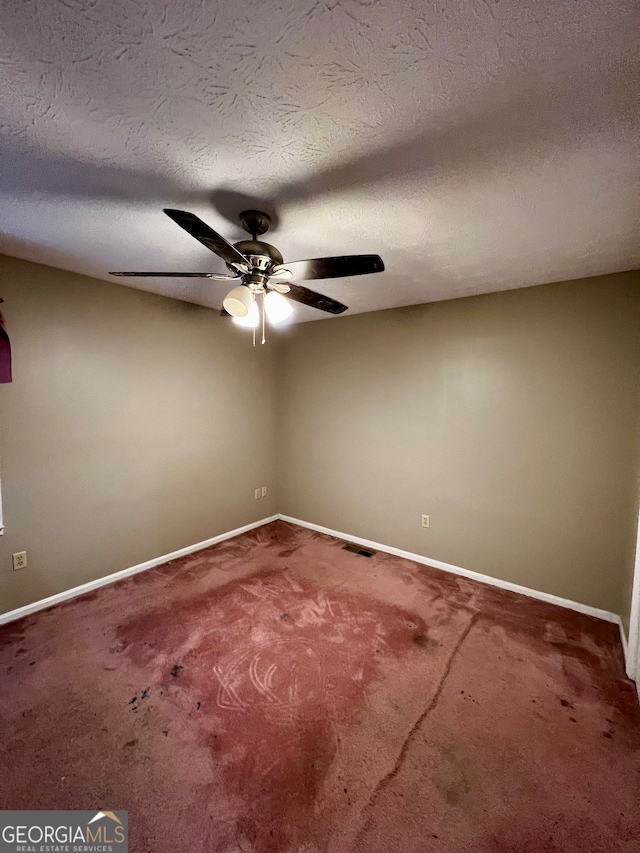 spare room featuring carpet and a textured ceiling