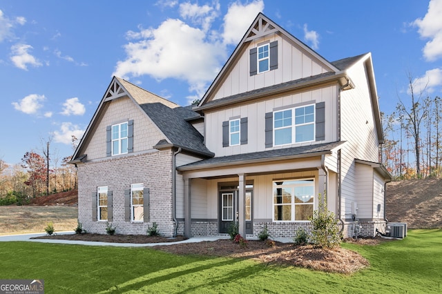 craftsman house featuring central AC unit and a front lawn