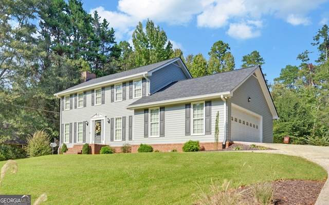 colonial home featuring a garage and a front yard