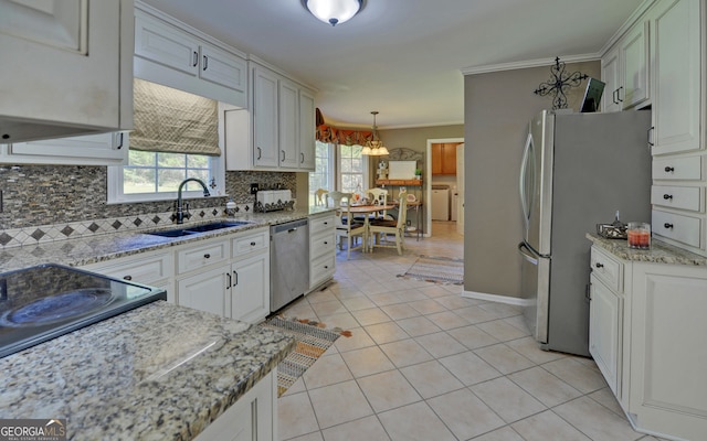 kitchen featuring sink, crown molding, light tile patterned floors, appliances with stainless steel finishes, and pendant lighting