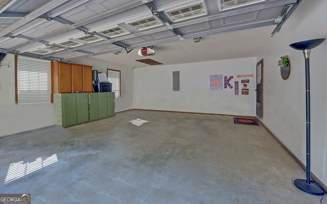 garage featuring a garage door opener and electric panel