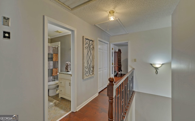 corridor featuring hardwood / wood-style flooring and a textured ceiling