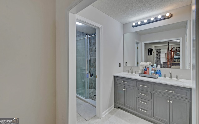 bathroom with vanity, an enclosed shower, tile patterned flooring, and a textured ceiling