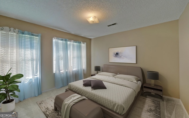 carpeted bedroom featuring a textured ceiling