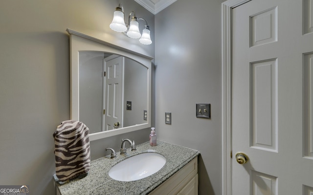 bathroom with ornamental molding and vanity