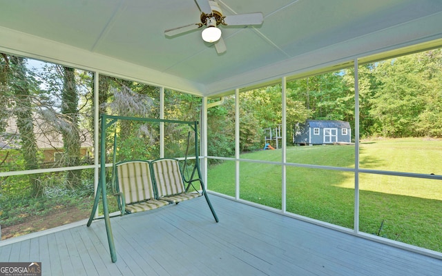 unfurnished sunroom featuring ceiling fan