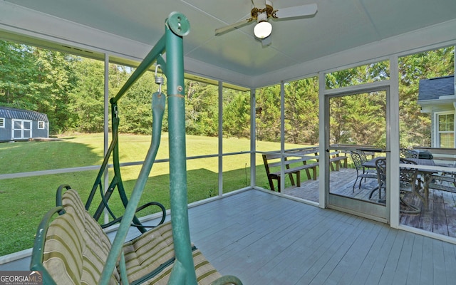 unfurnished sunroom featuring ceiling fan