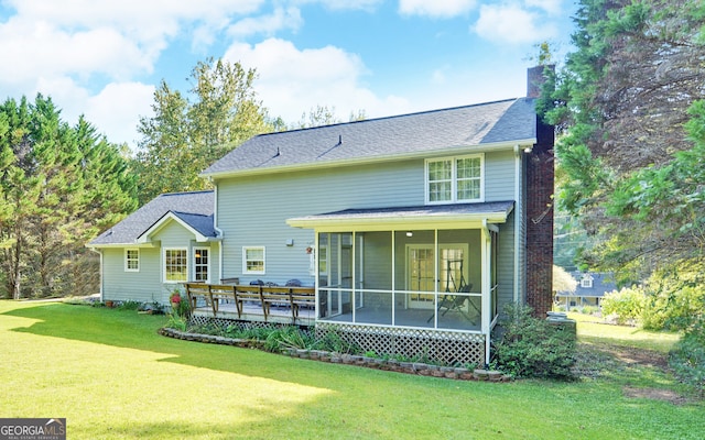 back of property featuring a wooden deck, a sunroom, and a yard