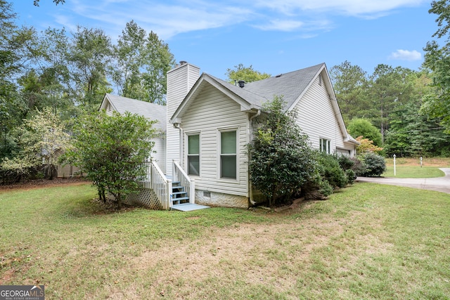 view of side of home with a lawn