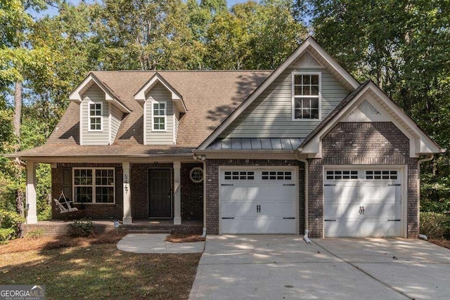 view of front of home featuring a porch and a garage