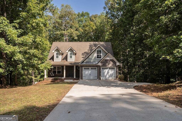 view of front of home featuring a front yard and a garage