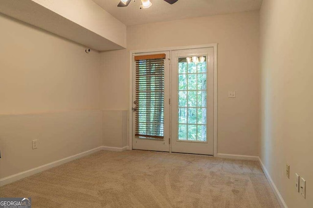 spare room with light carpet and ceiling fan