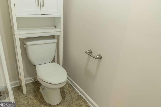 bathroom featuring tile patterned flooring and toilet