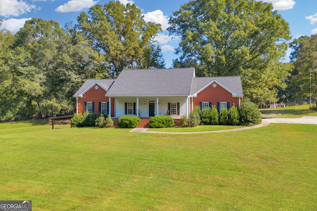 ranch-style house featuring a front lawn and covered porch