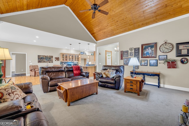 carpeted living room with wooden ceiling, crown molding, high vaulted ceiling, and ceiling fan