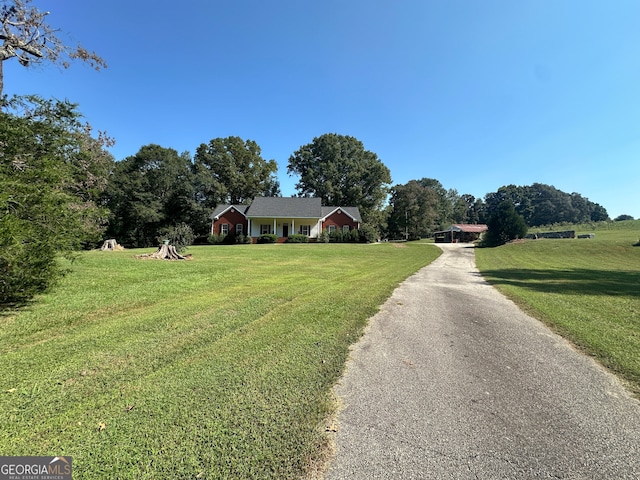 view of front of property with a rural view and a front lawn