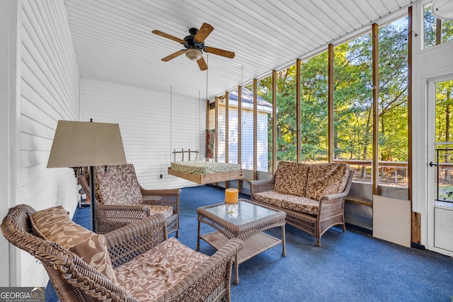 sunroom featuring ceiling fan