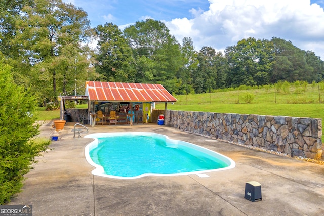 view of pool featuring a lawn and a patio area