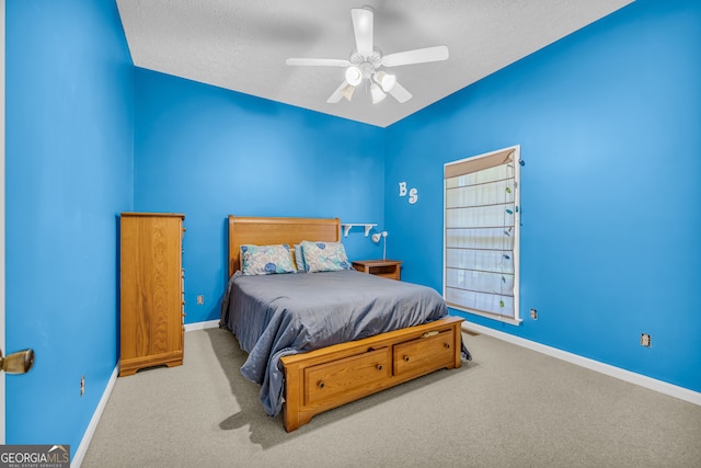 bedroom featuring light carpet, a textured ceiling, and ceiling fan