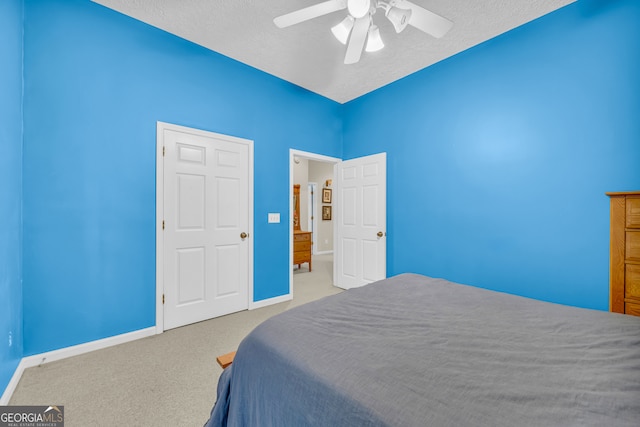 carpeted bedroom with a textured ceiling and ceiling fan