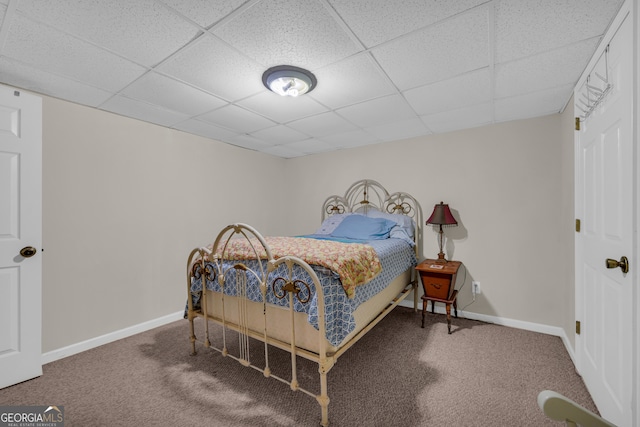 bedroom featuring carpet floors and a paneled ceiling