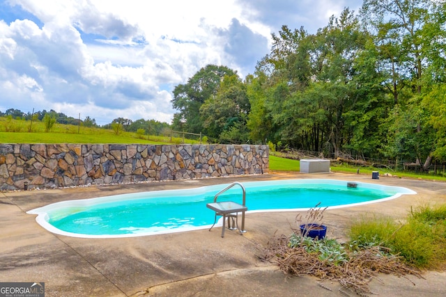 view of swimming pool featuring a patio area