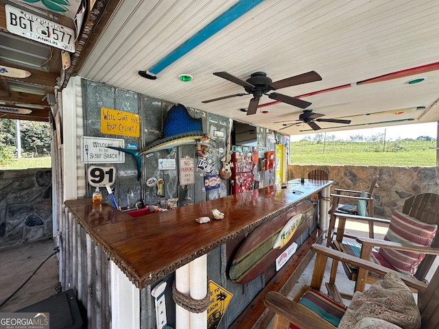 view of patio with ceiling fan and exterior bar