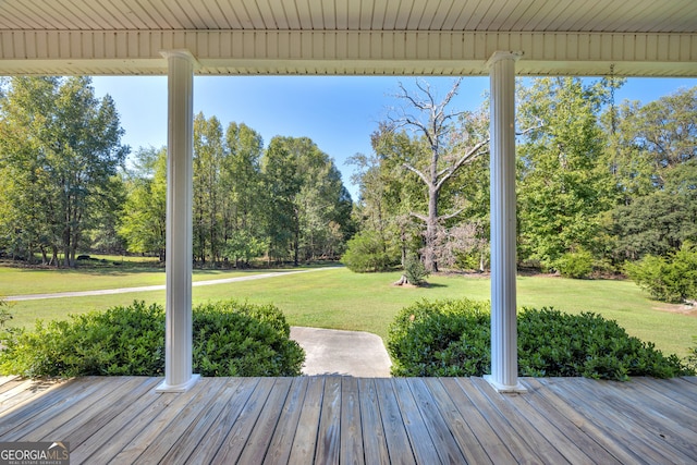 wooden terrace with a lawn