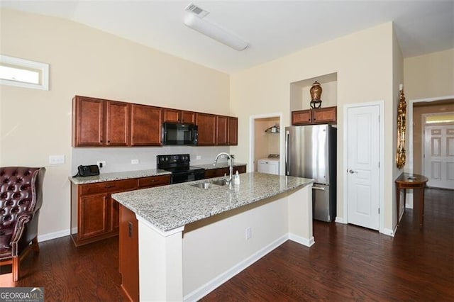 kitchen with sink, black appliances, dark hardwood / wood-style flooring, and a kitchen island with sink