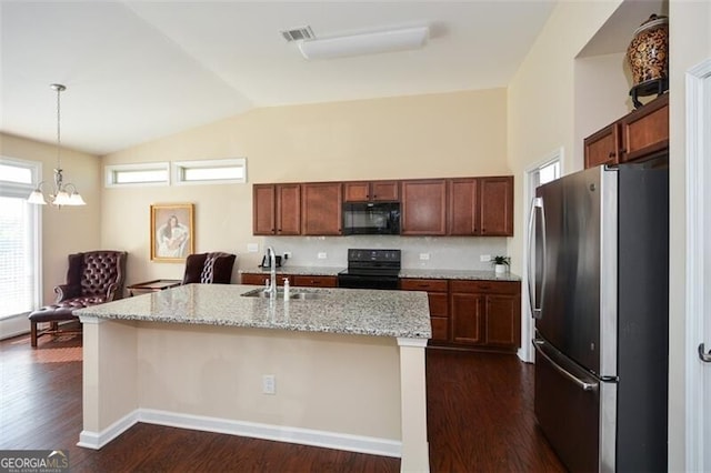 kitchen featuring black appliances, a kitchen island with sink, and dark hardwood / wood-style flooring