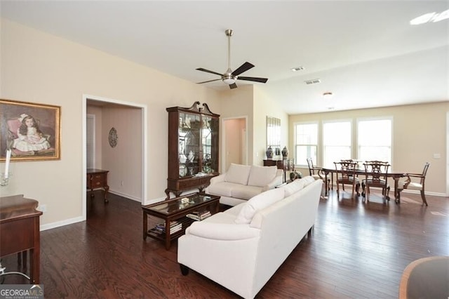 living room featuring ceiling fan, lofted ceiling, and dark hardwood / wood-style floors