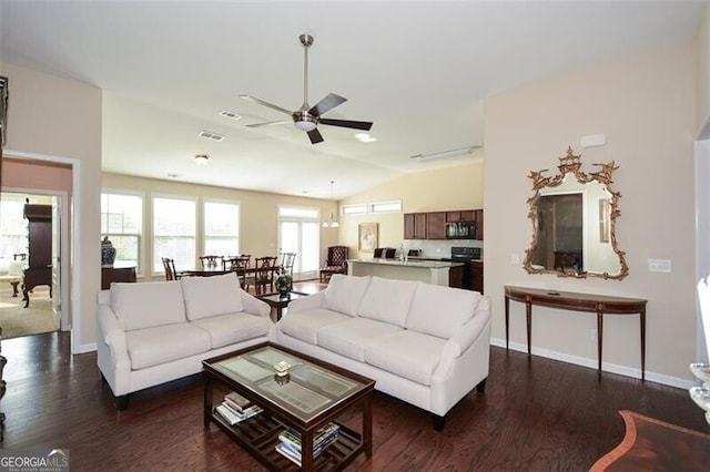 living room featuring ceiling fan, dark wood-type flooring, and vaulted ceiling