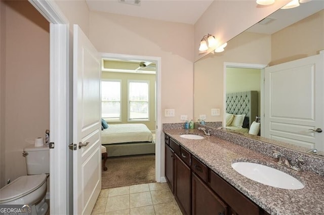 bathroom featuring ceiling fan, vanity, toilet, and tile patterned floors