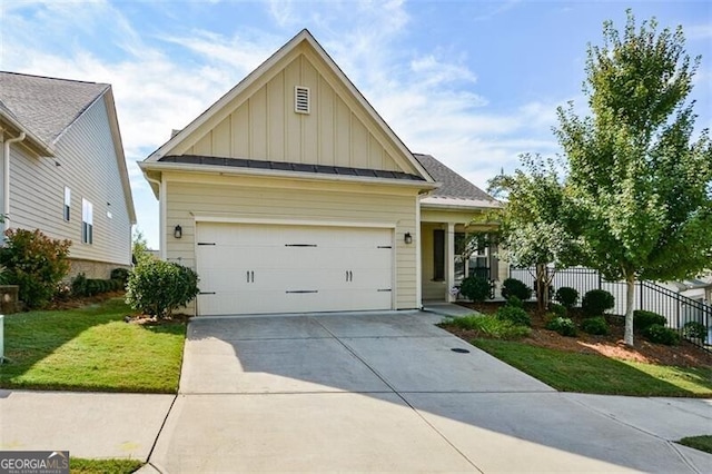 view of front of house featuring a garage and a front lawn