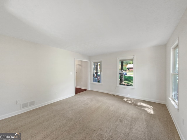 spare room with dark colored carpet