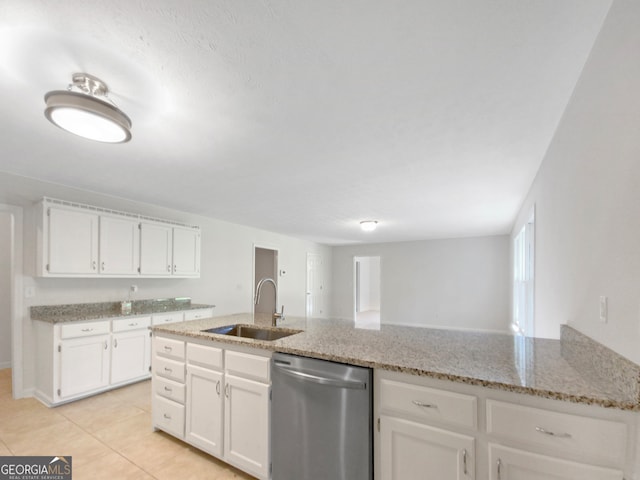 kitchen with sink, light stone counters, dishwasher, white cabinets, and light tile patterned floors