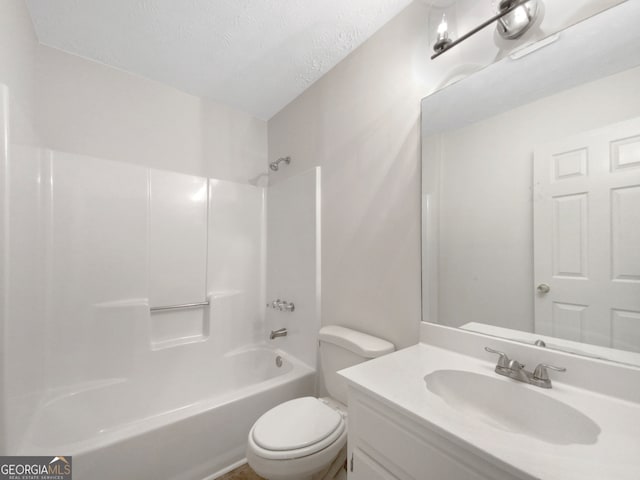 full bathroom with bathing tub / shower combination, vanity, a textured ceiling, and toilet