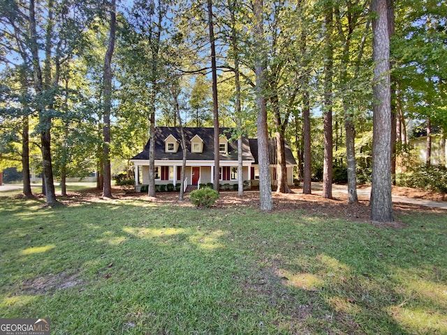 cape cod home with a front yard