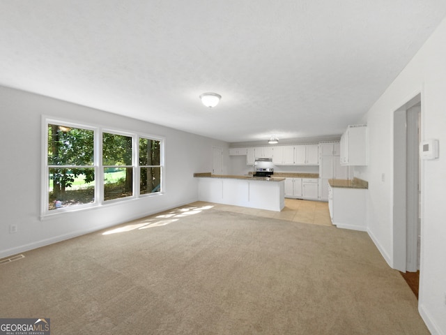 unfurnished living room featuring light carpet