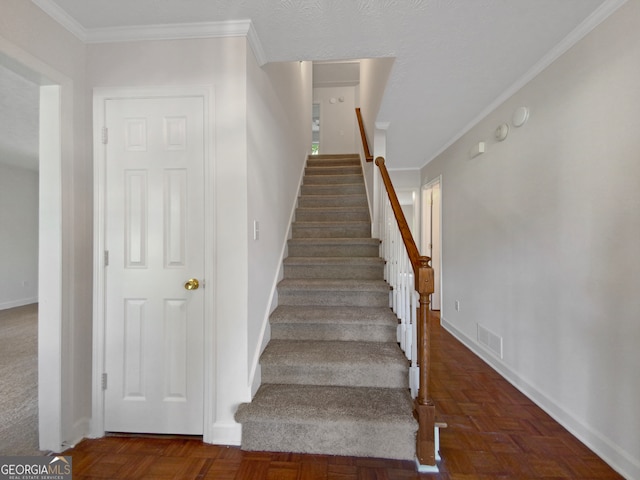 staircase featuring parquet floors and ornamental molding