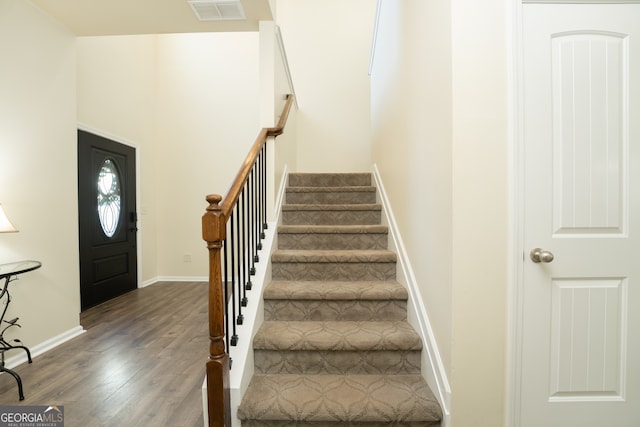 entryway with dark hardwood / wood-style flooring