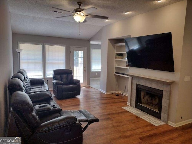 115 Elberta St, Mcdonough, GA 30253 - living area with wood finished floors, vaulted ceiling, a ceiling fan, and visible vents