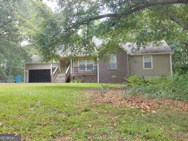 single story home with a garage, a front lawn, and a porch