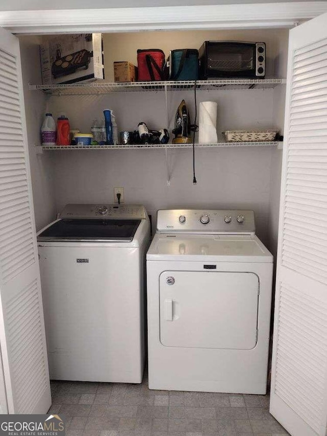 laundry area with independent washer and dryer