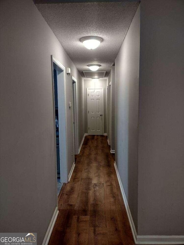 115 Elberta St, Mcdonough, GA 30253 - hall with a textured ceiling, dark wood-style flooring, and baseboards