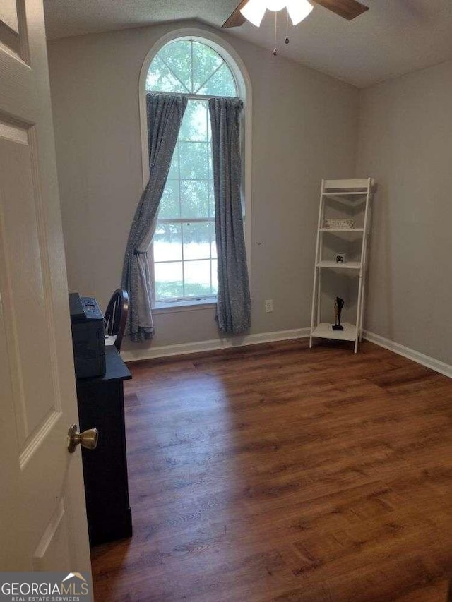 unfurnished bedroom featuring ceiling fan, dark hardwood / wood-style floors, and a textured ceiling