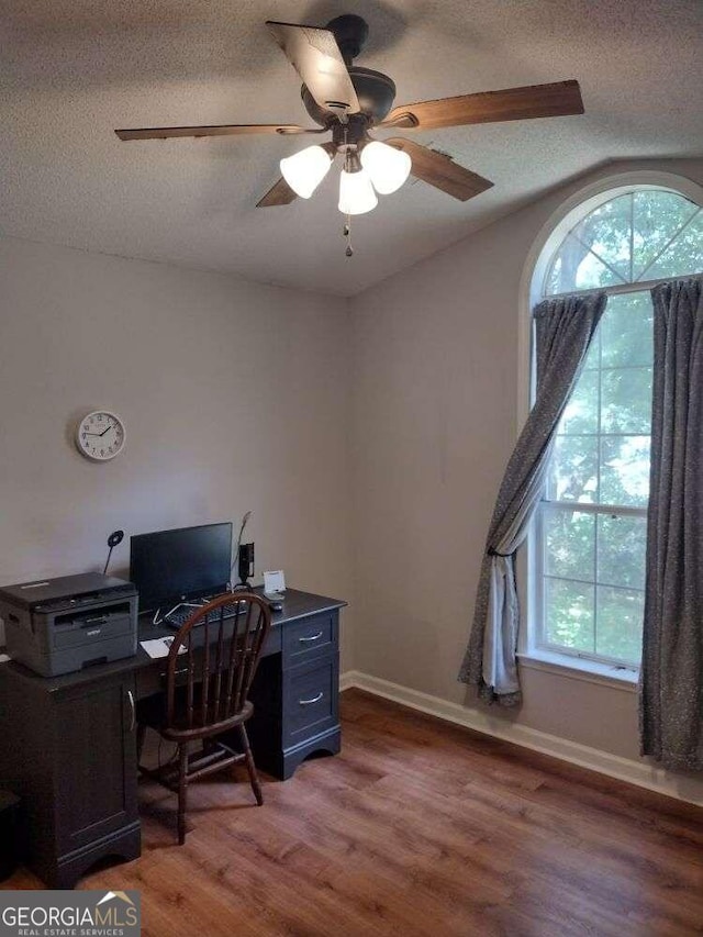 office area featuring ceiling fan, a textured ceiling, and dark hardwood / wood-style floors