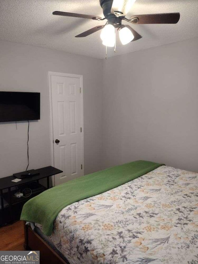 115 Elberta St, Mcdonough, GA 30253 - bedroom with ceiling fan, wood finished floors, and a textured ceiling