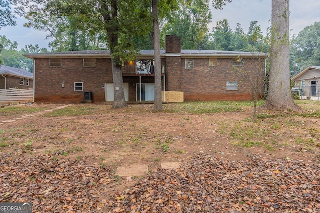 back of property featuring cooling unit and a balcony