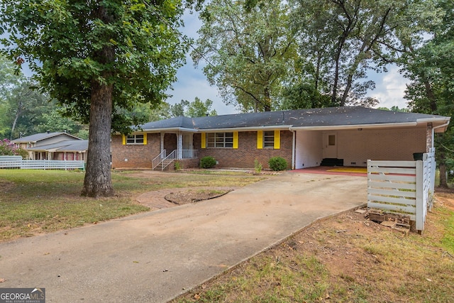 ranch-style house featuring a carport